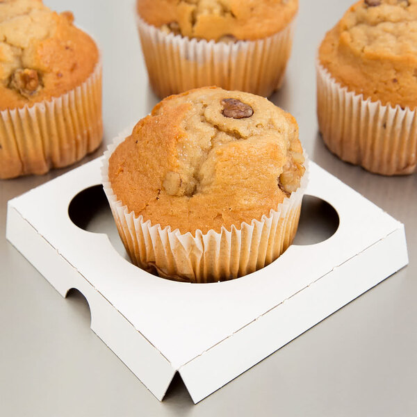 A group of muffins in a white Baker's Mark container.