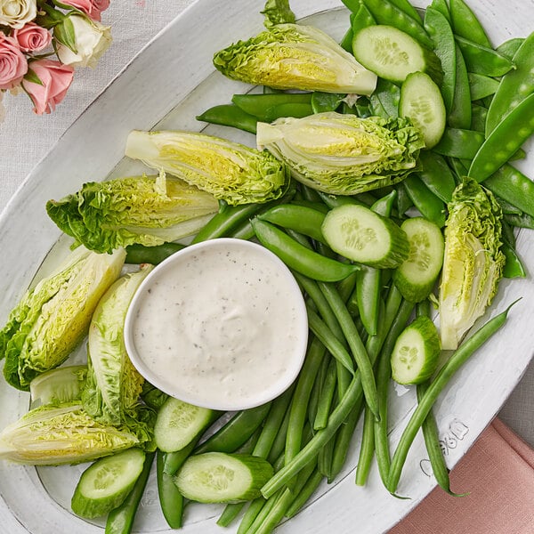 A plate of lettuce and green beans with Follow Your Heart vegan ranch dressing.