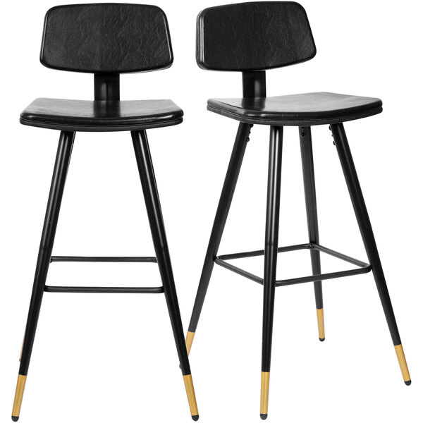 Two Flash Furniture black LeatherSoft bar stools with gold-tipped legs.