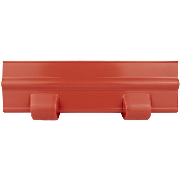 A red plastic object with hooks.