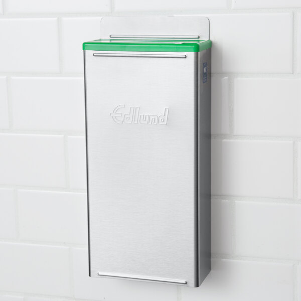 An Edlund stainless steel knife rack with green insert.