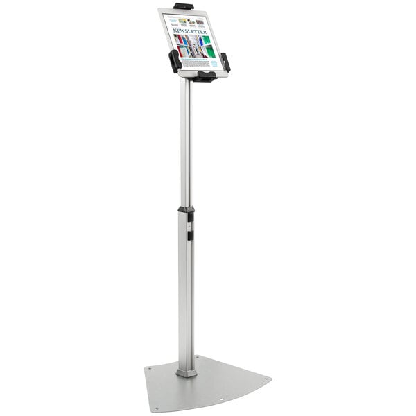 A metal floor mounted tablet stand with a silver pole and a tablet on it.