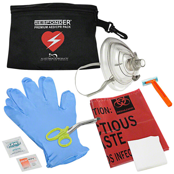 A black CPR/AED pack with a red heart and white text, medical supplies, gloves, a mask, and a pair of scissors with a green handle inside.