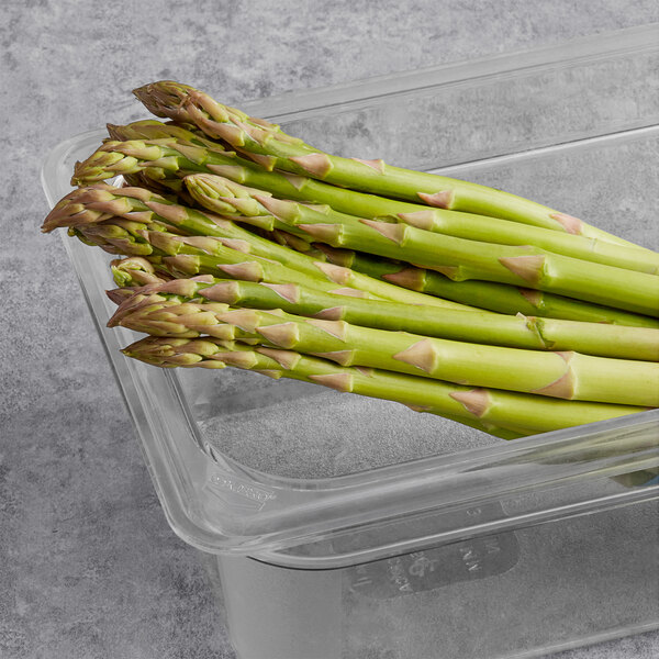 A plastic container of Fresh Standard asparagus spears.