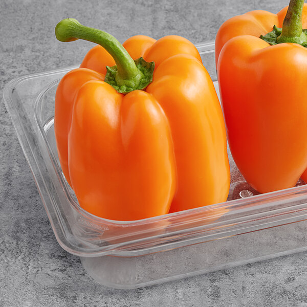 A plastic container of Fresh Greenhouse Orange Bell Peppers.