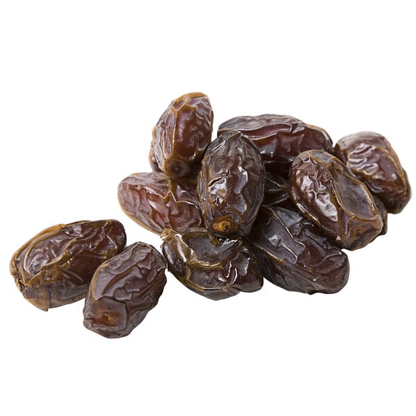 A pile of Fancy Dried Medjool Dates on a white background.