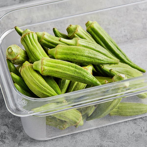 A plastic container of fresh okra.