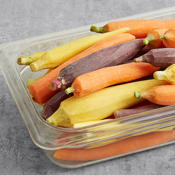 A plastic container of mixed color baby carrots.