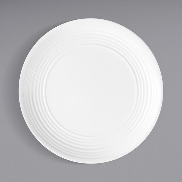 A Tablecraft white melamine plate with spiral lines.