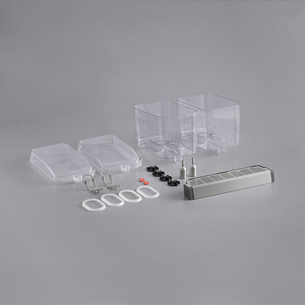 Clear plastic Crathco containers with clear lids on a white surface.