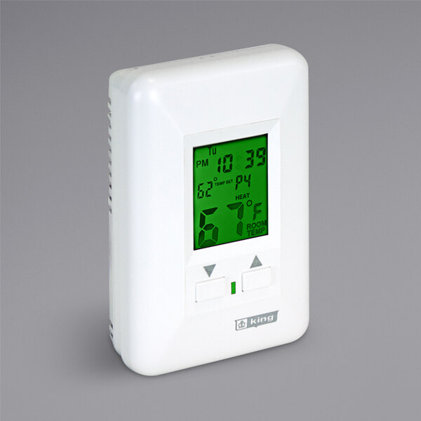 A white electronic thermostat with a green digital screen.