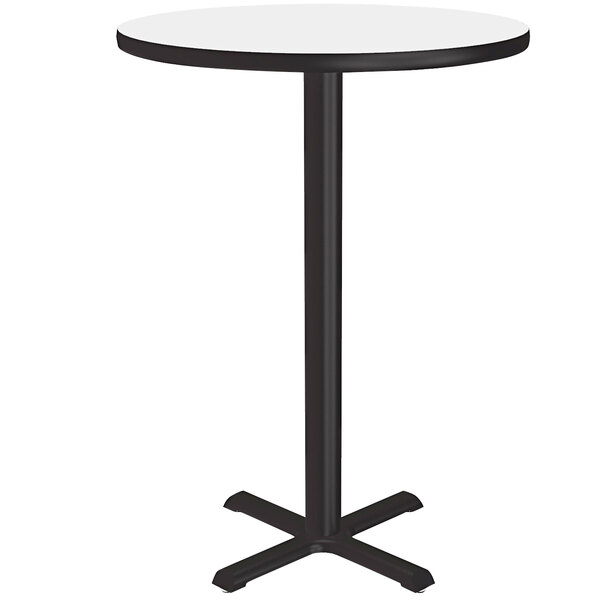 A round white high-pressure dry erase board table top on a black table base.