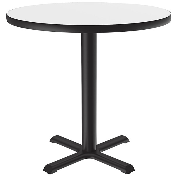 A Correll round bar height table with a white dry erase board top and black base.