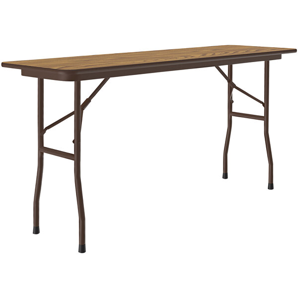 A Correll rectangular folding table with a medium oak wood top and brown metal frame.