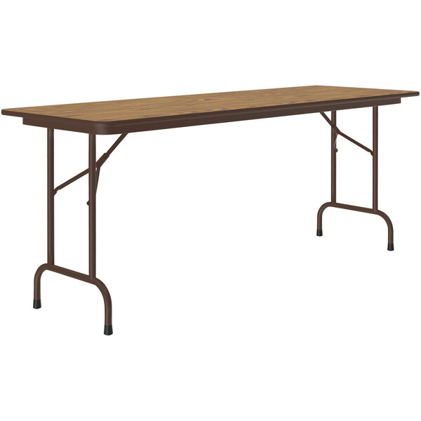 A rectangular Correll folding table with a medium oak top and brown metal frame.