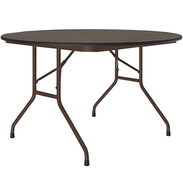 A Correll round walnut folding table with metal legs.