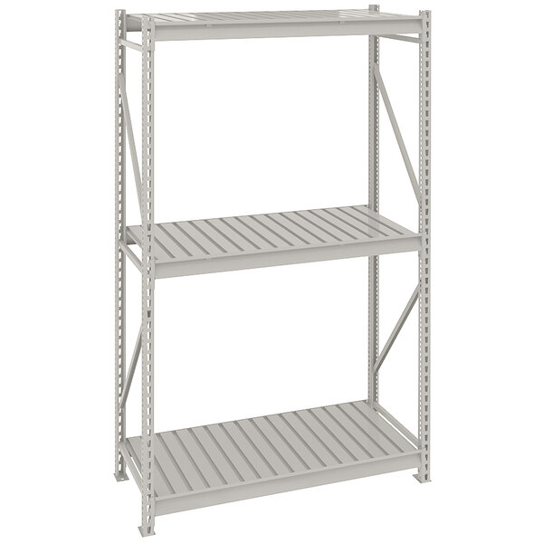 A light gray metal Tennsco boltless shelving unit with corrugated shelves.