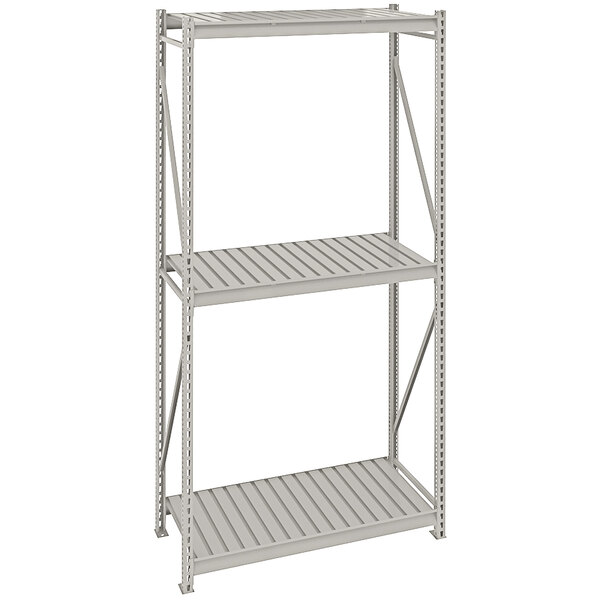 A light gray metal Tennsco boltless shelving unit with corrugated decking.