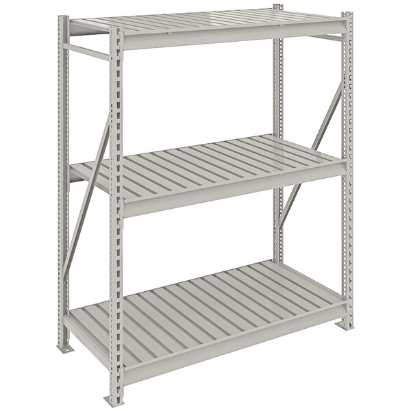 A light gray metal Tennsco boltless shelving unit with corrugated decking.