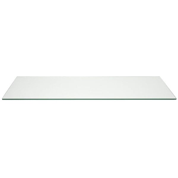 A clear rectangular glass buffet board on a white table.