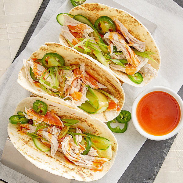 A group of chicken tacos with Sauce Craft Cayenne Pepper Sauce.