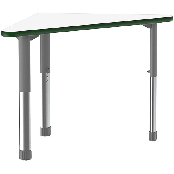 A triangular white Correll desk with metal legs and a green band.