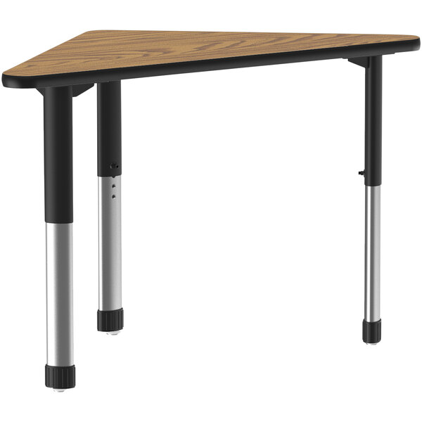 A Correll triangular table with a medium oak top and black metal legs.