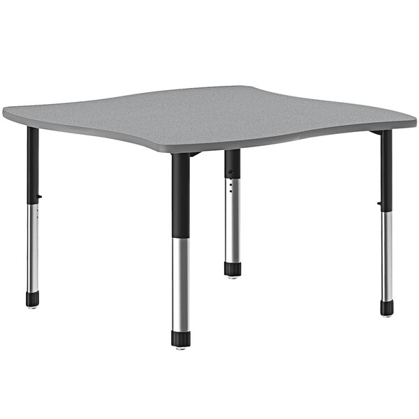 A gray rectangular Correll collaborative desk with a gray band and black legs.
