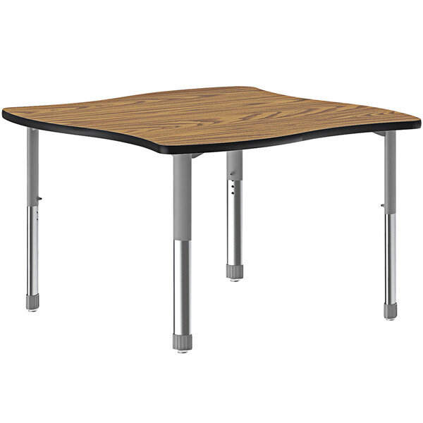 A rectangular Correll table with a wooden surface and two oak legs with black bands.