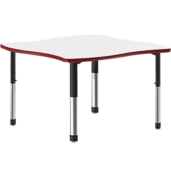 A white rectangular Correll collaborative desk with a red band and black legs.
