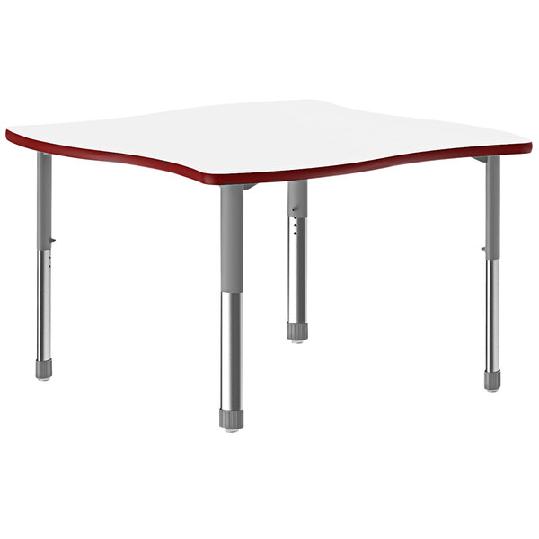 A white rectangular Correll collaborative desk with red trim and gray legs.