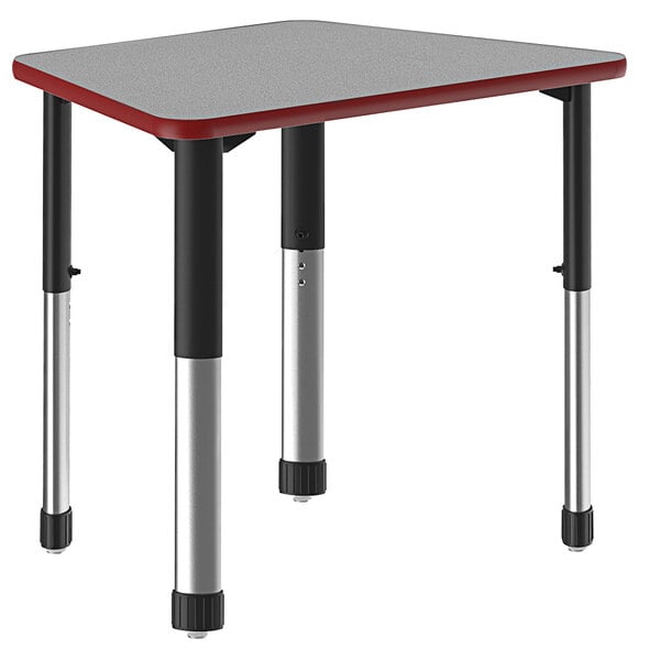 A trapezoid-shaped gray and red Correll collaborative desk with black legs.