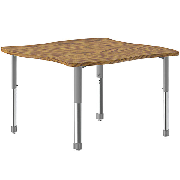 A rectangular wooden Correll collaborative desk with metal legs and a gray band.