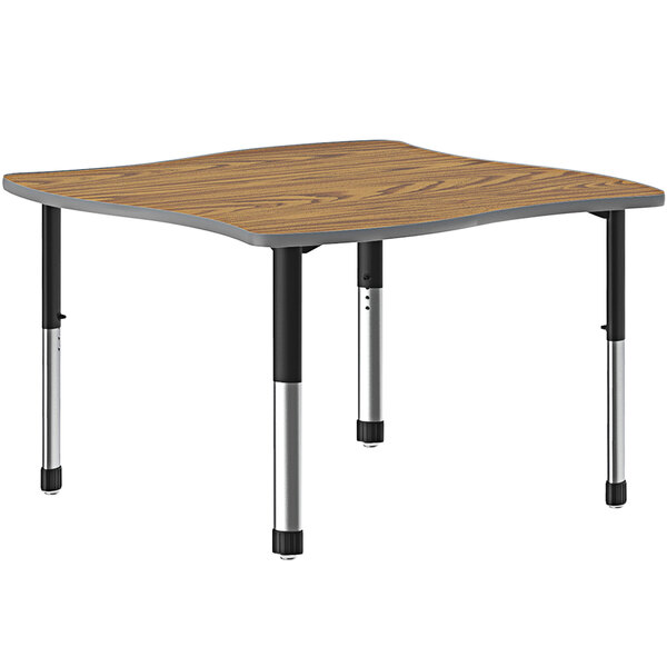 A rectangular Correll table with a wooden surface and black metal legs.