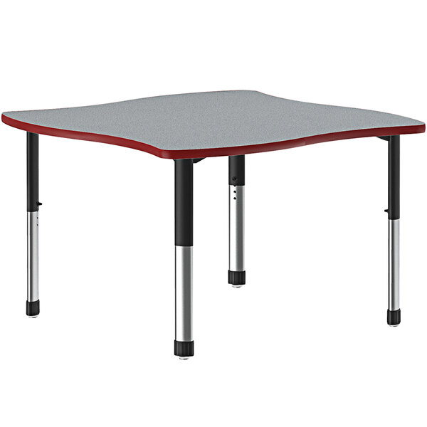 A grey rectangular Correll collaborative desk with black legs and a red band.