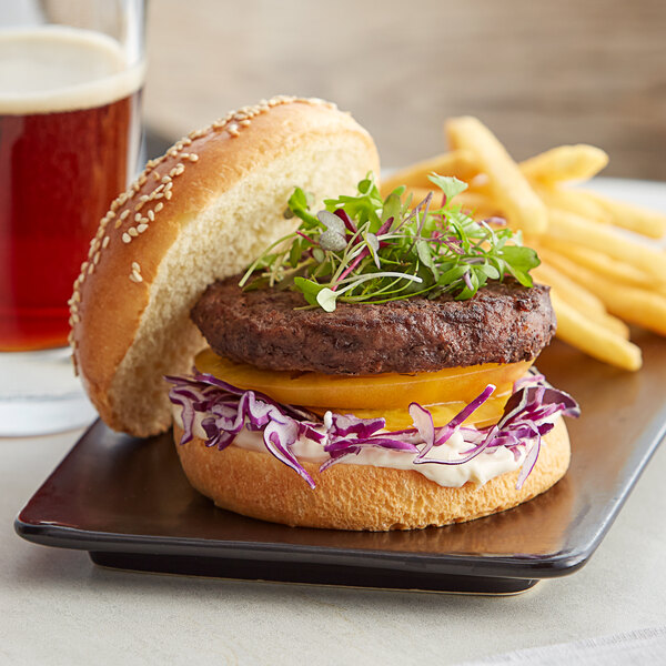 A close-up of a TenderBison burger with lettuce and cheese on a plate.