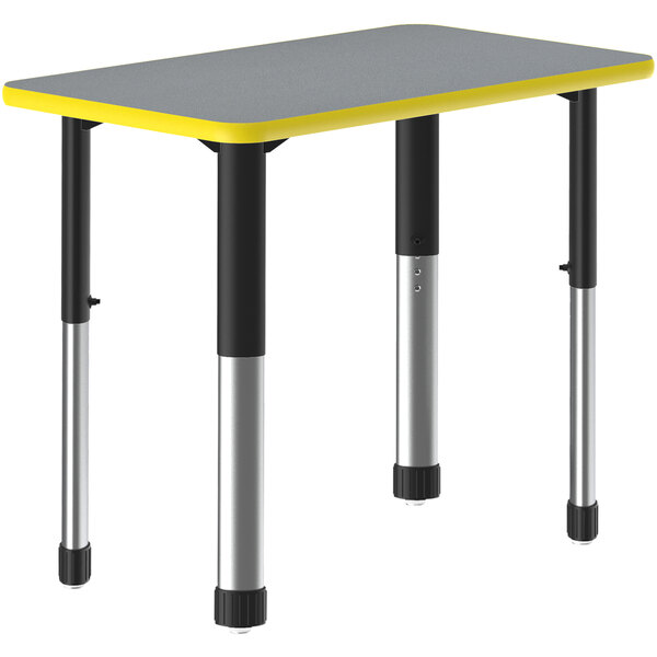 A grey and black rectangular Correll collaborative desk with yellow bands on the edges.