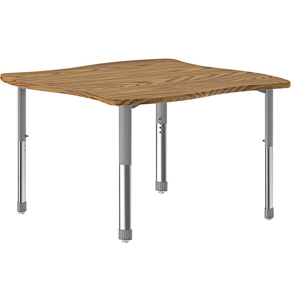 A Correll medium oak rectangular table with a wooden top and gray metal legs.