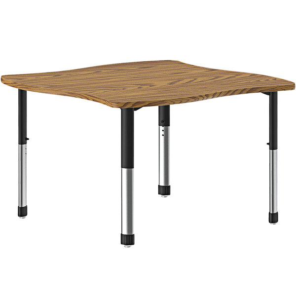 A Correll rectangular table with a medium oak top and metal legs.