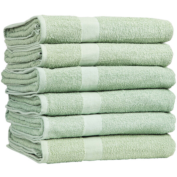 A stack of green Monarch Brands pool towels.