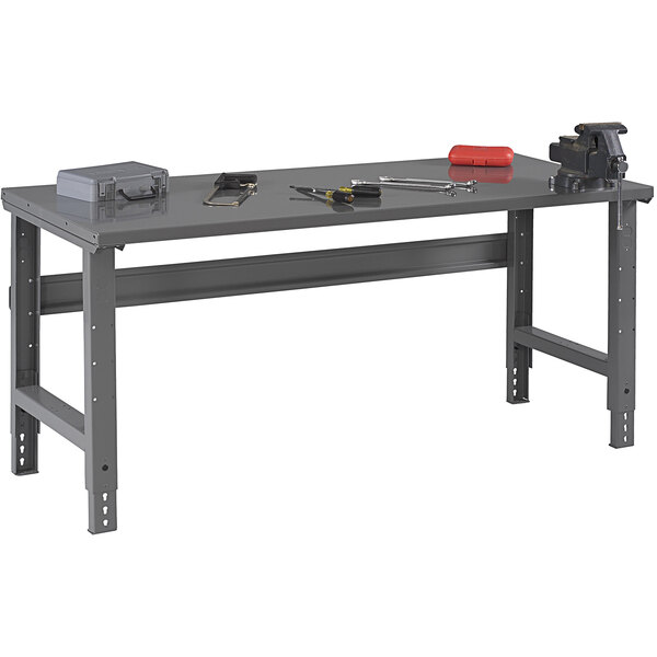 A grey Tennsco steel work table with tools on it.