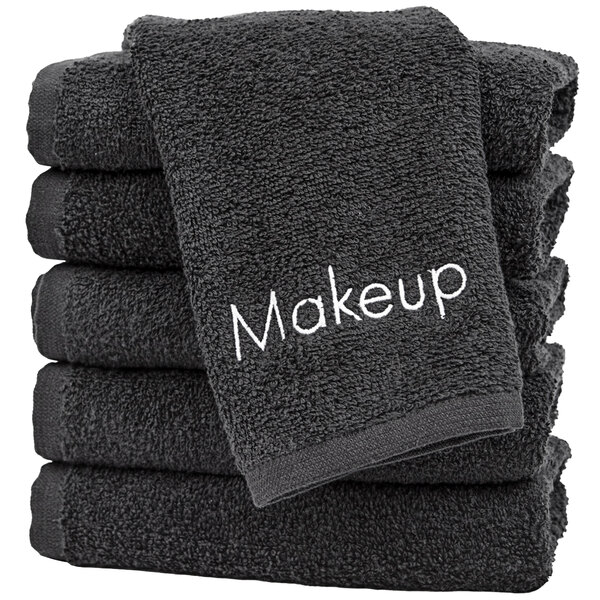 A stack of black Monarch Brands makeup wash cloths.