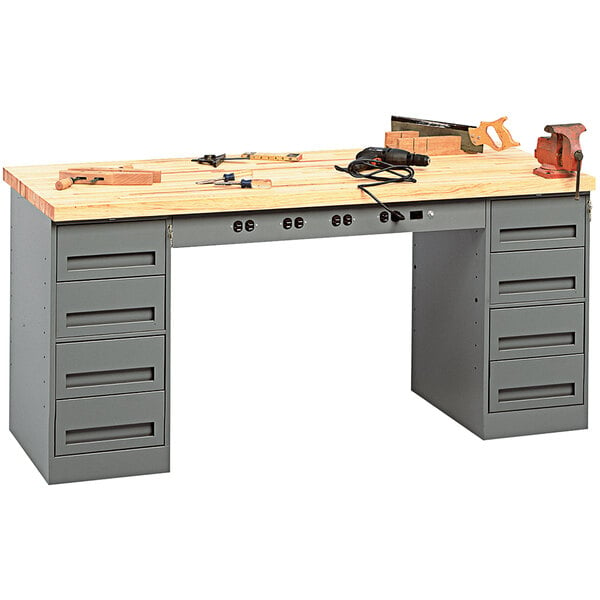 A Tennsco hardwood workbench with drawers and tools on it.