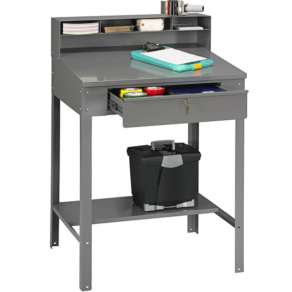 A gray Tennsco shipping/receiving desk with a black filing drawer.