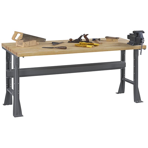 A wood workbench with tools on it.