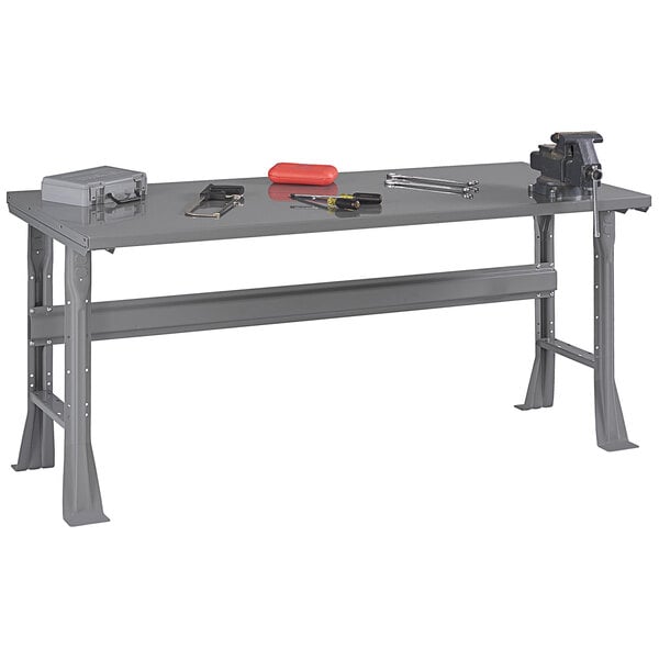 A grey workbench with tools on it.