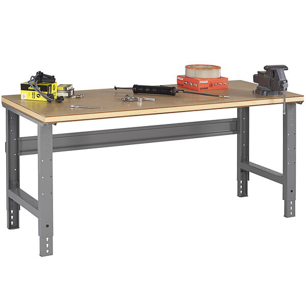 A Tennsco compressed wood workbench with tools on it.
