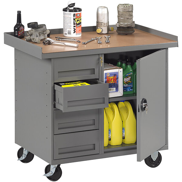 A gray Tennsco steel workbench with drawers and a cabinet.