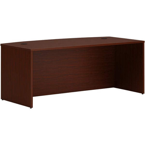 A rectangular brown mahogany desk.