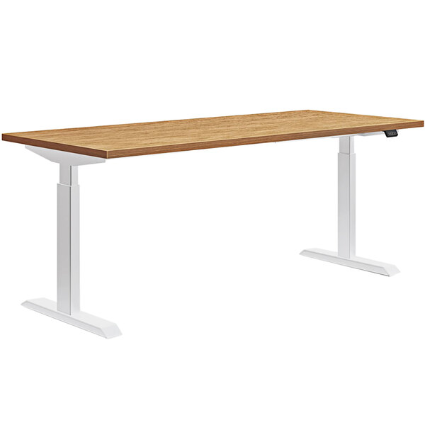 A HON Coze Coordinate natural recon and white height-adjustable desk with white legs.